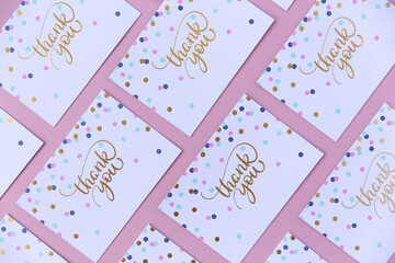 Thank you cards on pink background.