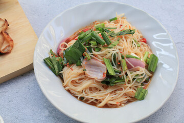 Papaya spicy Salad with Vermicelli. Tum Sua or Som Tum Delicious Thai food, diet concept. Asian salad with rice noodles and vegetables rice noodle salad.