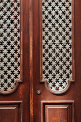 Detail of a beautiful typical and wooden door in Tavira, Algarve, Southern Portugal.