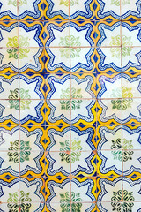 Beautiful wall with typical tiles called azulejo in Tavira, Algarve, Southern Portugal.