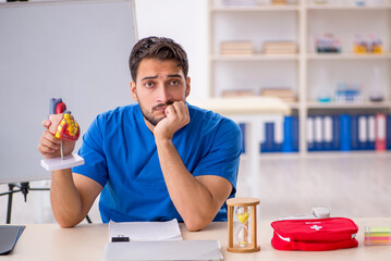 Young male doctor cardiologist working in the clinic