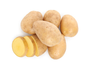 Whole and cut fresh potatoes on white background, top view