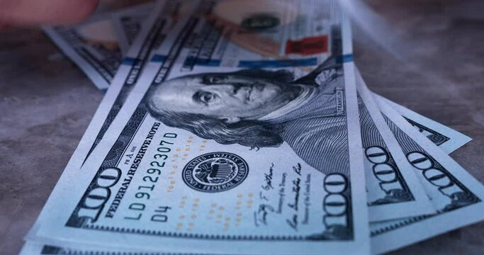 Close up of money counting, American cash dollars putting on the table bill by bill. Close-up of person counting accumulated cash savings. Closeup Bucks 100 USD dollar bills