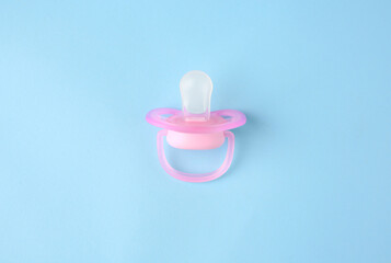 Fototapeta premium One new baby pacifier on light blue background, top view