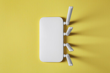 New white Wi-Fi router on yellow background, top view