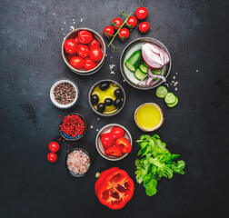 Vegetables, olives, oil and ingredients for cooking greek salad with feta cheese, cherry tomato, paprika, cucumber and red onion, healthy mediterranean food, low calories eating