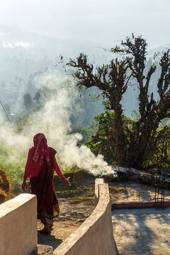 KASAUNI, February 2023: A woman cleaning her home front in Kausani village of Uttarakhand state of India. 