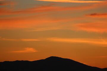 red sunset sky in the clouds, golden hour abstract clouds calm relax mountain silhouette dark