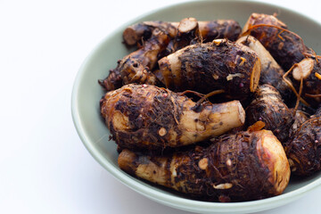 Organic taro fruit on white background.
