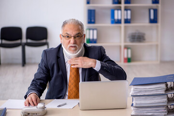 Old male employee after accident at workplace