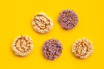 Rice cracker with coconut palm sugar on yellow background.