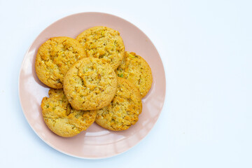 Pistachio and almond cookies on white background.