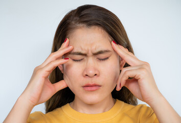 Asian woman having headaches from migraine. Headaches are a common health problem it cause from stress, depression or high blood pressure etc.