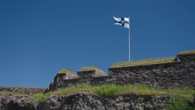 Old flag of Finland Waving With The Wind Against The Blue Sky. - wide static