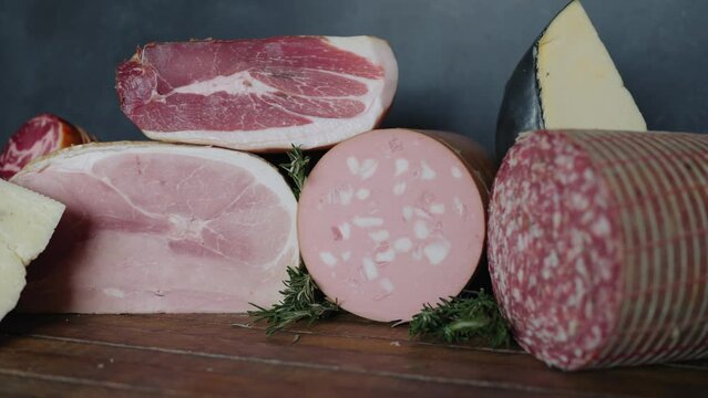 Italian deli meats and cheeses on display in a restaurant. Prosciutto, salami, mortadella, and various cheeses in an Italian deli restaurant.