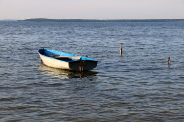 Naklejka premium Rowing boat on the shore of Lake Naroch.