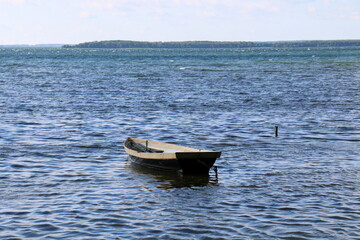 Naklejka premium Rowing boat on the shore of Lake Naroch.