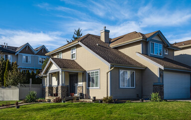 Real Estate Exterior Front House. Big custom made luxury house with nicely landscaped front yard and driveway to garage