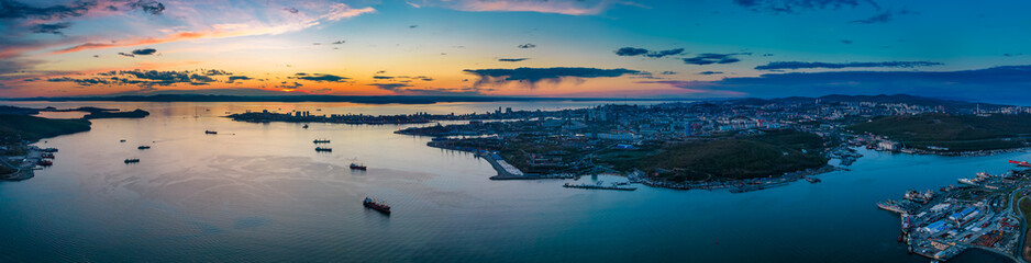 Sunset aerial panorama of Vladivostok city surrounded by Sea of Japan, Far East of Russia