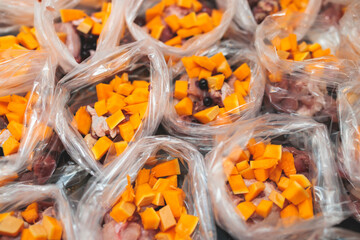 Process of preparing bowls with natural raw pet dog food at home, preparation of healthy raw barf for cats dogs, with duck, turkey, offals, meat, vegetables, assorted fresh portions in containers bags