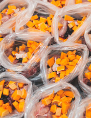 Process of preparing bowls with natural raw pet dog food at home, preparation of healthy raw barf for cats dogs, with duck, turkey, offals, meat, vegetables, assorted fresh portions in containers bags