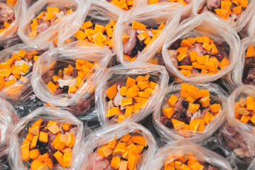 Process of preparing bowls with natural raw pet dog food at home, preparation of healthy raw barf for cats dogs, with duck, turkey, offals, meat, vegetables, assorted fresh portions in containers bags