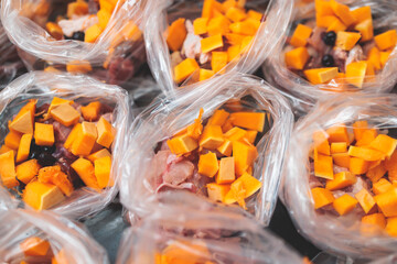 Process of preparing bowls with natural raw pet dog food at home, preparation of healthy raw barf for cats dogs, with duck, turkey, offals, meat, vegetables, assorted fresh portions in containers bags