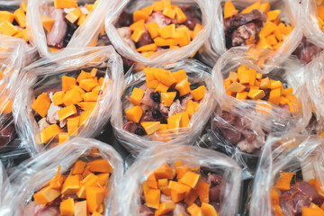 Process of preparing bowls with natural raw pet dog food at home, preparation of healthy raw barf for cats dogs, with duck, turkey, offals, meat, vegetables, assorted fresh portions in containers bags