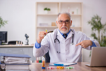 Old male doctor pharmacist in drugs synthesis concept