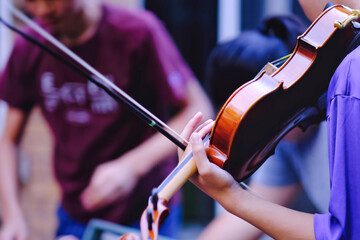 Close up pf teen high school students playing violin at outdoor. Youth art, music club lifestyle...