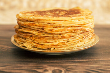 Delicious pancakes with chocolate sauce fresh blueberries on a rustic wooden table. Rustic brown table. 