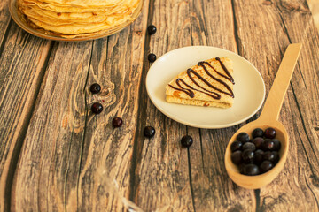 Delicious pancakes with chocolate sauce fresh blueberries on a rustic wooden table. Rustic brown table. 