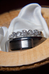 close up of wedding rings in keepsake box, We do, wooden tree log branch holder