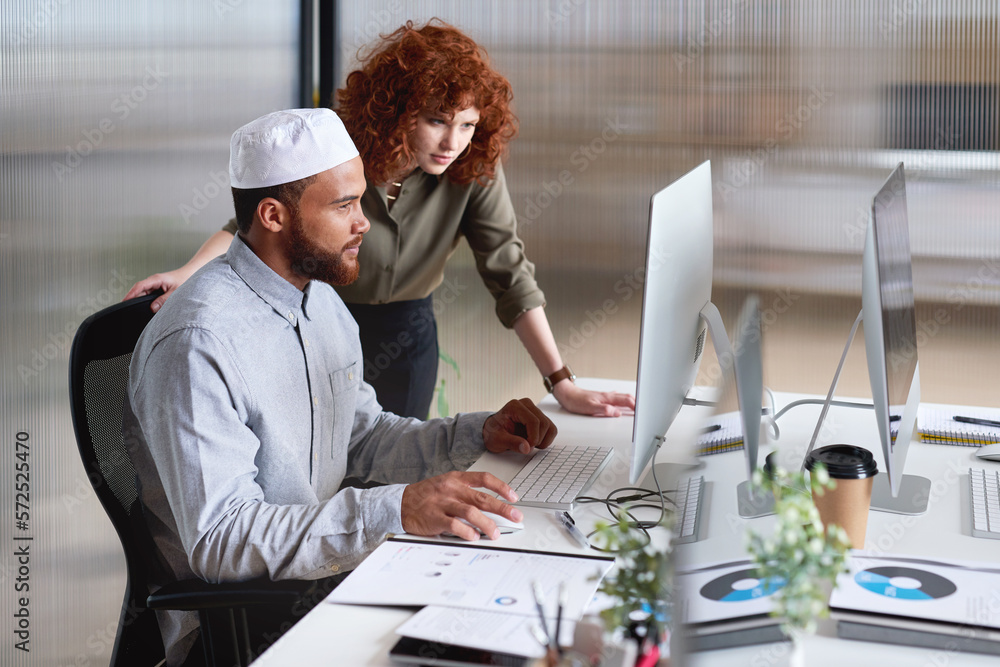 Poster muslim, islamic and diverse colleagues working together on a computer planning a web design at a sta