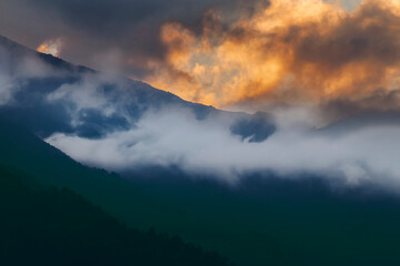 White cloud of the Himalayan mountain range, sun set sky in the background. Shot at Okhrey, Sikkim, India.