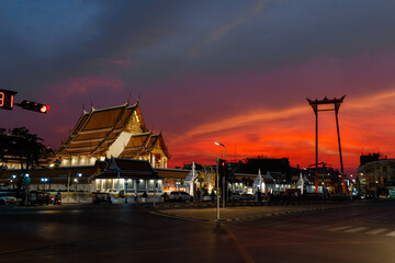 Bangkok, Thailand - January 27, 2023: Giant swing (Sao Ching Cha) and Wat Suthat temple at sunset