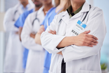 Doctors team, arms crossed and cropped at hospital with teamwork, diversity and solidarity for healthcare. Doctor, nurse and group for motivation, service and collaboration in clinic for wellness