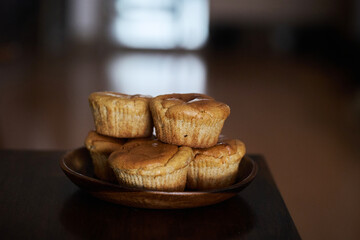 sweet muffins stacked on table