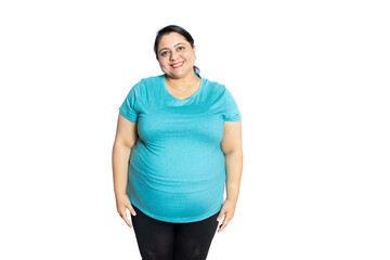 Happy overweight indian woman looking at camera standing isolated over white background studio...