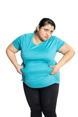 Depressed overweight indian woman holding big belly waistline suffering from excess fat. Worried...