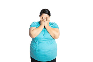 Young overweight indian woman covering eyes with hands feeling embarrassed, Plus size asian female with sad and fear expression. Body Shaming and obesity concept. - obrazy, fototapety, plakaty