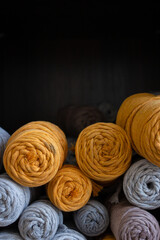 Multicolored cotton balls of yarn and ropes for macrame close up