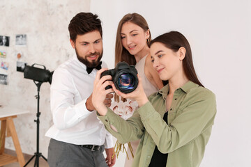 Female photographer working with couple in studio