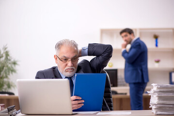 Two male colleagues working in the office