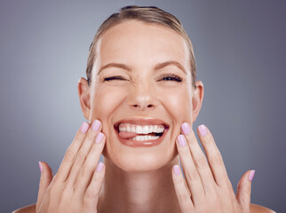 Skincare, comic and portrait of a woman touching face isolated on a grey studio background. Funny,...
