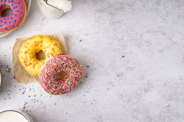 Parchment with delicious donuts on white table