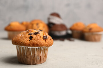 Delicious muffin with chocolate chips on table