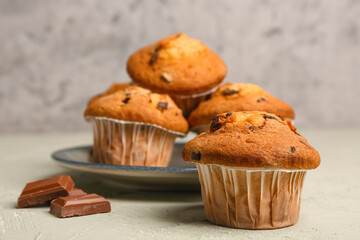 Plate of tasty muffins on table