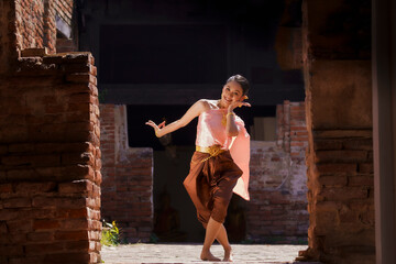 A beautiful lady  in Thai traditional costume shows traditional basic Thai dance. © Samruay