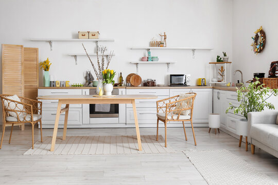 Interior of kitchen with Easter decor, white counters and dining table